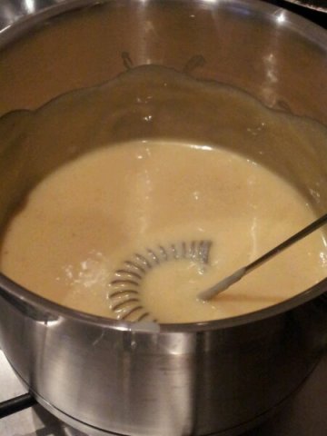 Whisking the condensed milk over a low heat to make doce de leit