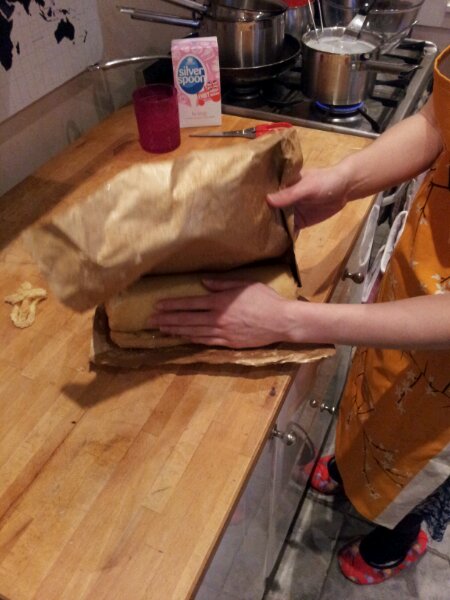 Use the baking paper as a lever to roll the rocambole up