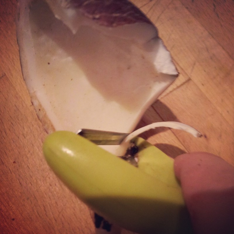 Shaving a coconut to create coconut curls