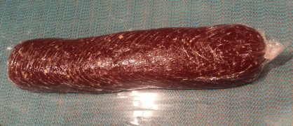 a cling film wrapped chocolate sausage