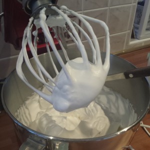 Whisk the egg whites (adding the sugar gradually) until stiff peaks are formed 