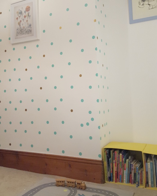 Image of duck egg blue and gold polka dots on bedroom wall