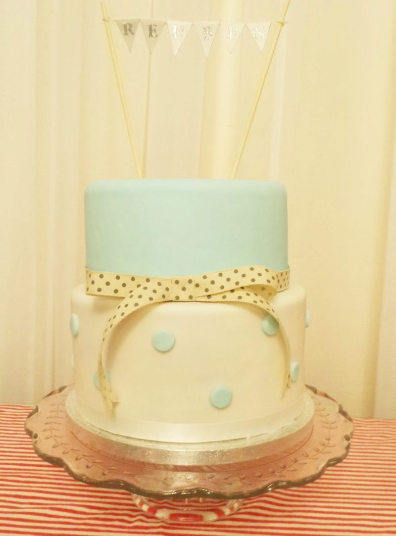 Christening cake. Two tiered iced fruit cake with duck egg blue polka dots and bunting